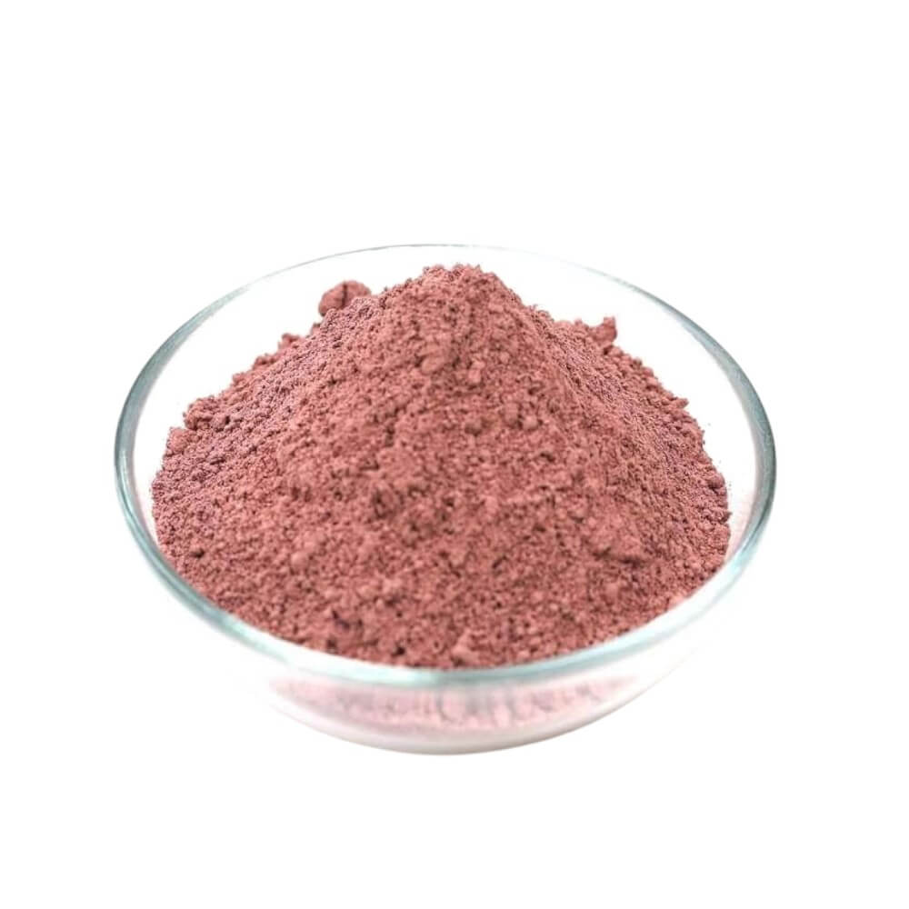 Rose clay powder in a glass dish.